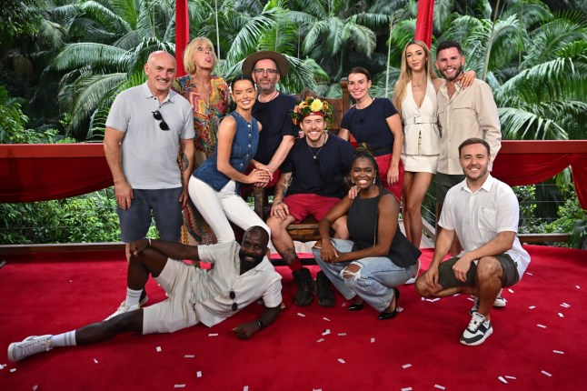 Danny Jones is crowned King of the Jungle and poses on his throne with runner-up Coleen Rooney, third place Richard Coles and campmates Oti Mabuse, Melvin Odoom, Maura Higgins, Jane Moore, Barry McGuigan, GK Barry, Alan Halsall and Dean McCullough on 'I'm a Celebrity...Get Me Out of Here!' TV show set
