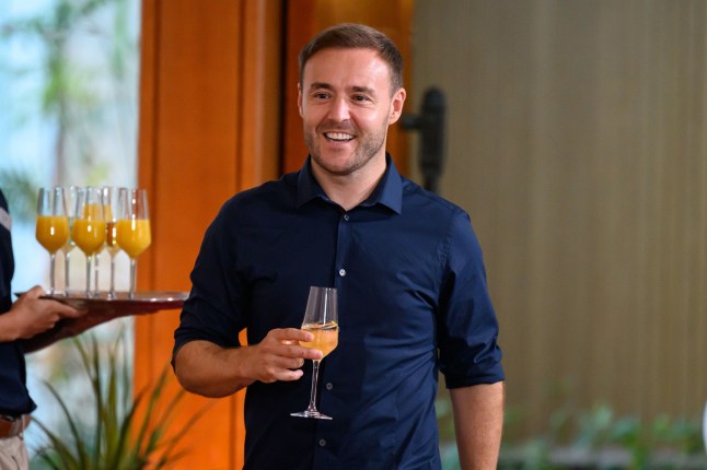 Alan Halsall holding a glass of champagne after leaving I'm a Celebrity Get Me Out of Here