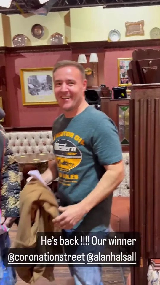 Alan Halsall walks into the Rovers Return in Coronation Street, captioned 'He's back, our winner.'