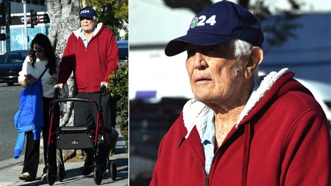 Former James Bond star George Lazenby is photographed out for a walk with a zimmer frame the day Amazon took creative control of the 007 franchise