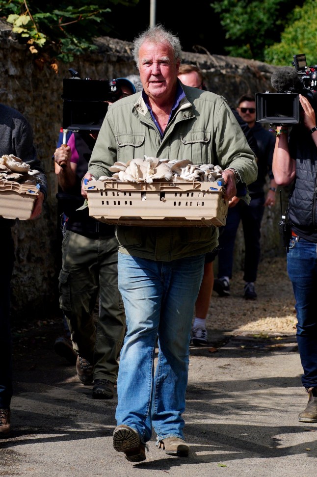 Jeremy Clarkson carrying mushrooms at the opening of his new pub, The Farmer's Dog, in Asthall, near Burford in Oxfordshire. Picture date: Friday August 23, 2024. PA Photo. The former Top Gear presenter is opening amid fears the venture may bring more traffic problems following the success of his Diddly Squat farm shop, with residents expressing concerns about traffic problems because the pub is located next to the busy A40 road. See PA story SHOWBIZ Clarkson. Photo credit should read: Ben Birchall/PA Wire