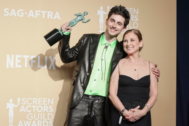 Actor Timothee Chalamet stands with his mother, Nicole Flender, while holding the SAG award