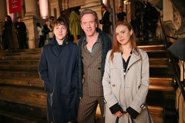 LONDON, ENGLAND - FEBRUARY 24: Damian Lewis (C) poses with children Gulliver McCrory-Lewis and Manon McCrory-Lewis at the Burberry Winter 2025 show during London Fashion Week on February 24, 2025 in London, England. (Photo by Jed Cullen/Dave Benett/Getty Images for Burberry)