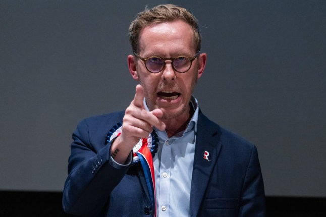 Laurence Fox points at audience as he speaks