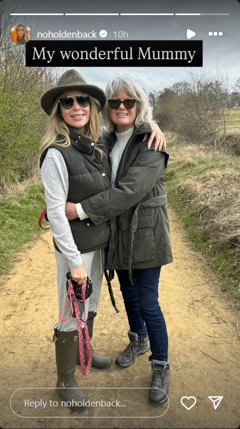 Amanda Holden smiles while out on a dog walk, embracing her mother Judith
