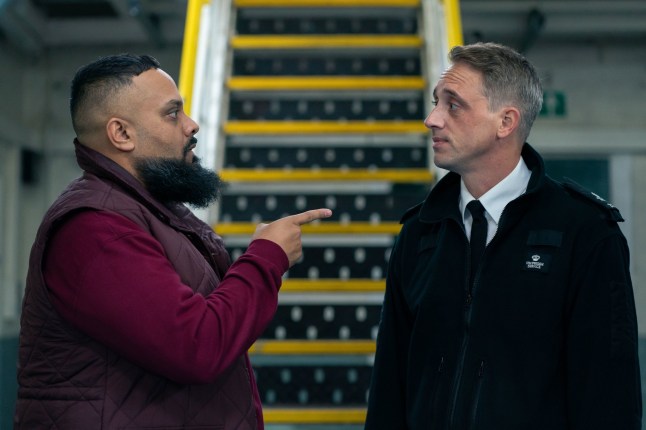Guz Khan as Mobeen and Perry Fitzpatrick as Officer Harper looking at one another in front of a set of stairs in Man Like Mobeen