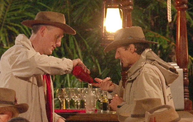 Lembit Opik squeezing ketchup on Nigel Havers' finger in I'm a Celeb
