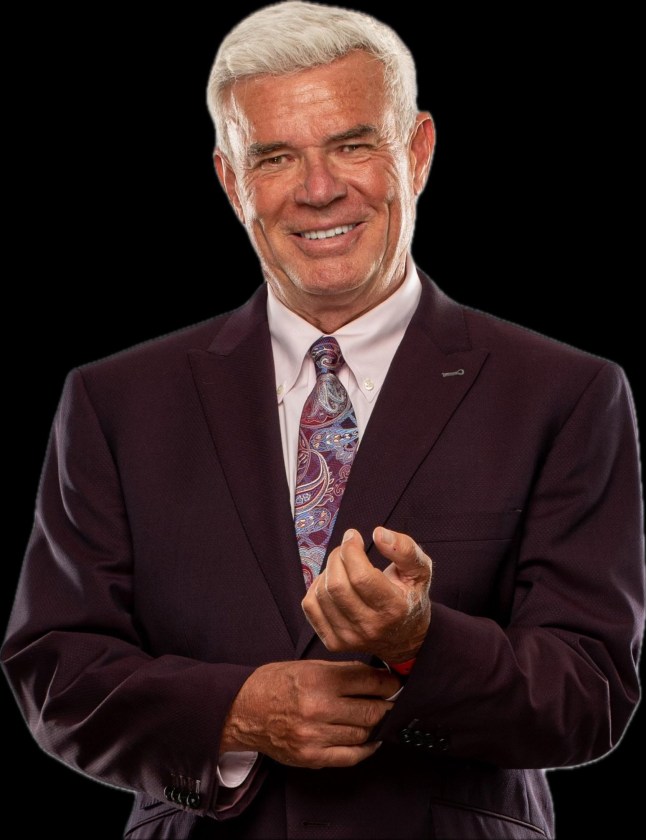 WCW and WWE legend Eric Bischoff smiles in a suit in a portrait photo