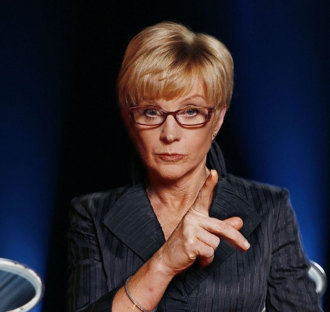 Anne Robinson pointing her finger on The Weakest Link set, looking stern.