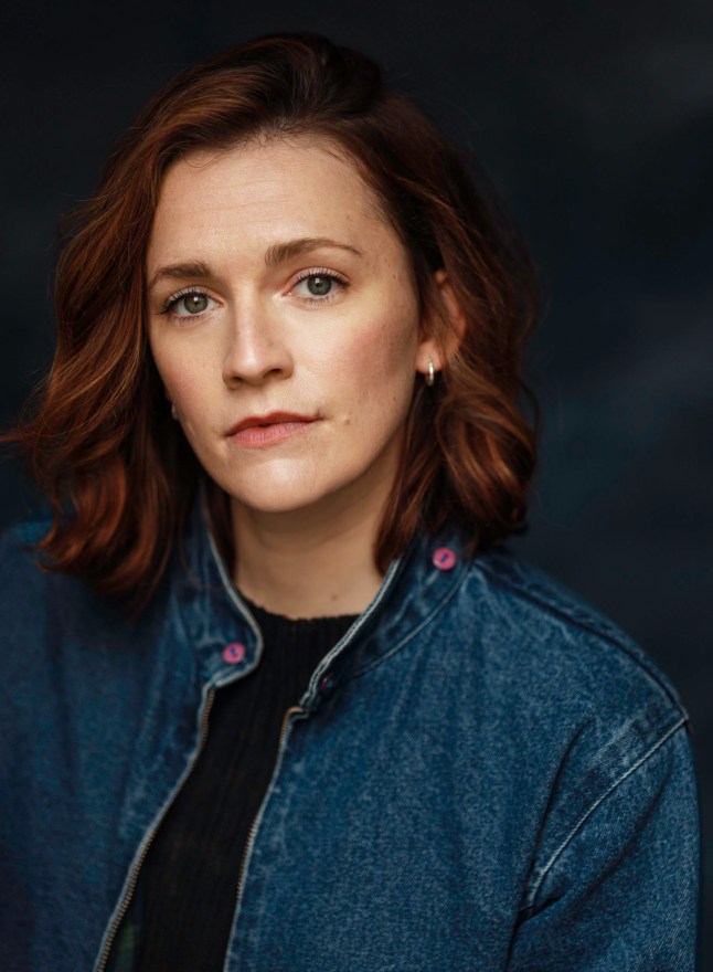 A close up of Charlotte Ritchie wearing a dark denim jacket and black shirt