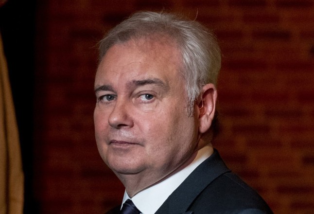 Eamonn Holmes looking serious wearing a black suit