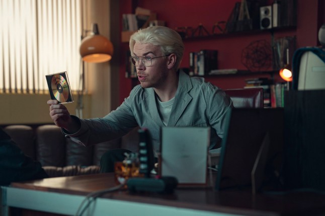 Will Poulter as Colim Ritman in a grey jumper sat at a desk in Bandersnatch sequel, Plaything