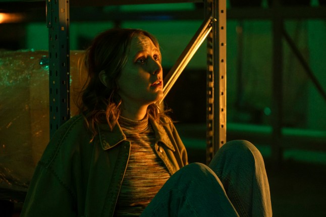 Rose Ayling-Ellis as Alison in Code of SIilence sat on the floor in a dark room looking up