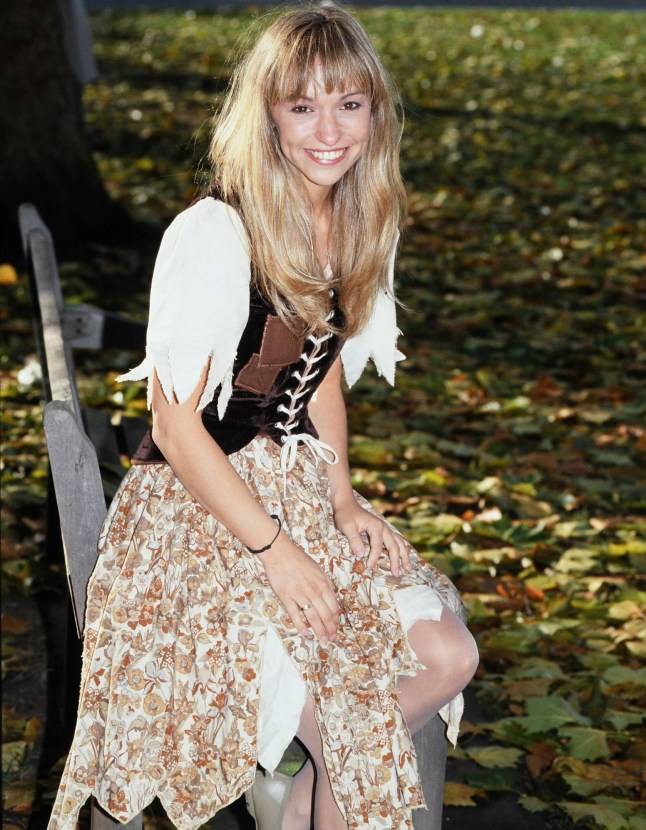 Michaela Strachan wearing a brown and white floral skirted dress and smiling to the camera in the 80s