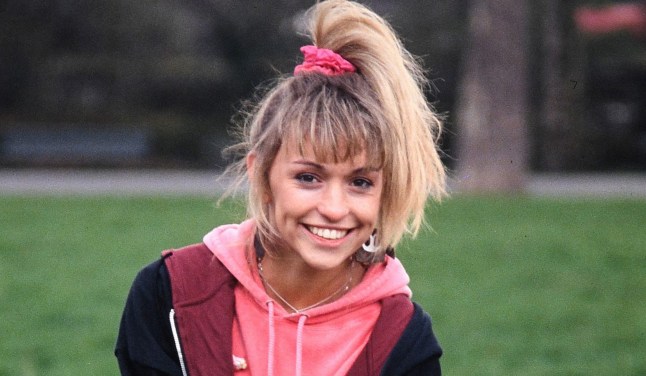 Michaela Strachan in the 80s wearing a bright pink jumper and her hair tied up in a bright pink scrunchie