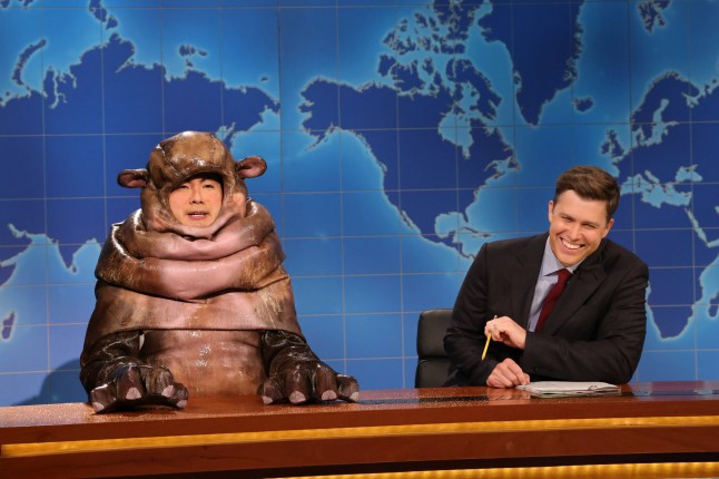 Bowen Yang as Moo Dang the hippo and Colin Jost during Weekend Update on Saturday Night Live